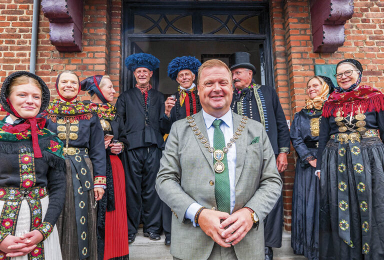 Under fejringen af kommunens 50-års-jubilæum stiller borgmester Kenneth Gøtterup og borgere klædt i amagerddragter op til fotografering foran Dragørs gamle rådhus på Stationsvej. Foto: TorbenStender.